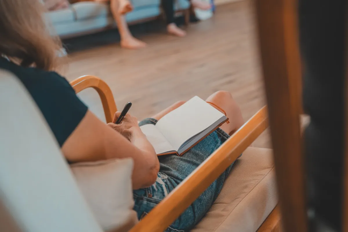 Close-up journaling detail at retreat