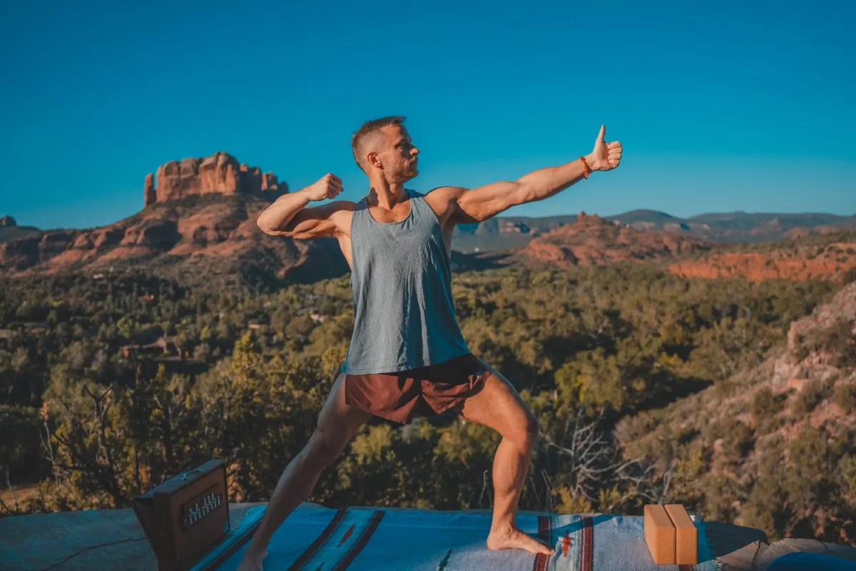 Jack in warrior yoga pose with Sedona red rocks